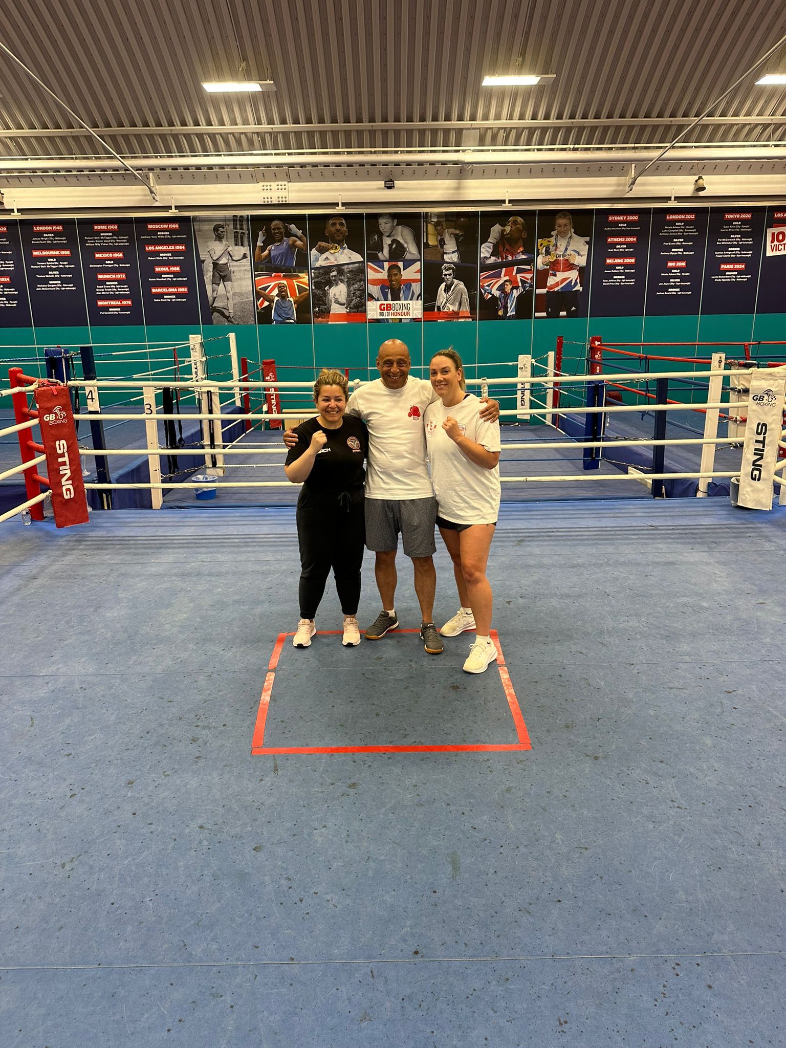 Rachel in the ring with other England Boxing coaches